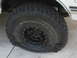 1990 Ford Bronco - A vehicle has a flat tire, showing the sidewall details of the tire.