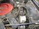 1987 Ford Bronco - Close-up view of an engine compartment showing various engine parts and hoses.