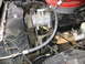 1987 Ford Bronco - Close-up view of an engine compartment, showing various mechanical components and hoses.