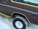1979 Ford Bronco - A brown 1979 Ford Bronco navigates through snowy conditions, highlighting its side profile and a yellow step assist.