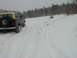 1979 Ford Bronco - A 1979 Ford Bronco navigates a snow-covered path through a wooded area.