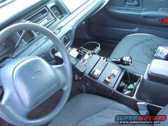 1999 Ford Crown Victoria interior with police equipment, including radio and flashlight