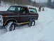 1979 Ford Bronco - Ford Bronco navigating a snowy landscape, likely off-road.