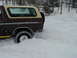1979 Ford Bronco - Ford Bronco driving through deep snow, kicking up a spray.