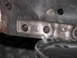 1980 Ford Bronco - Close-up of a cast metal engine block part with stamped markings.