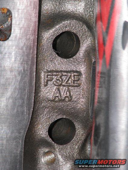 Close-up of cast metal part with 'FSZE AA' stamped on it