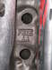 1980 Ford Bronco - Cast metal part with stamped markings 'FSZE AA' and two circular openings.
