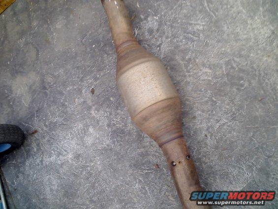 Used catalytic converter lying on a concrete floor