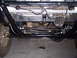 1980 Ford Bronco - Close-up view of the front suspension and steering system of an off-road vehicle.