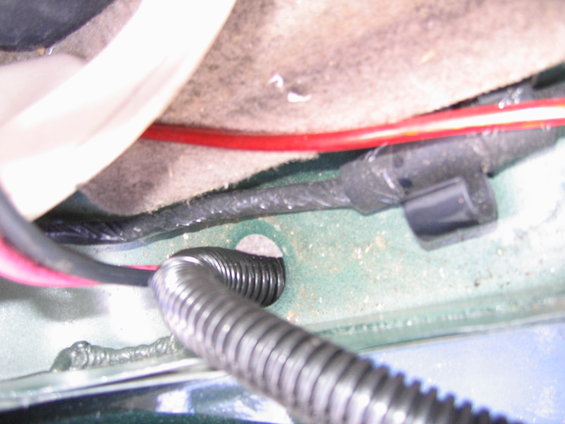 Harness pass through in passenger sill plate