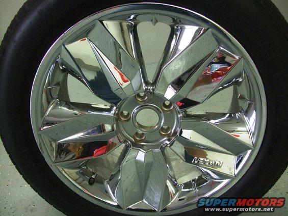 Chrome wheel with a black tire, showing a "LEXANI" logo on one of the spokes
