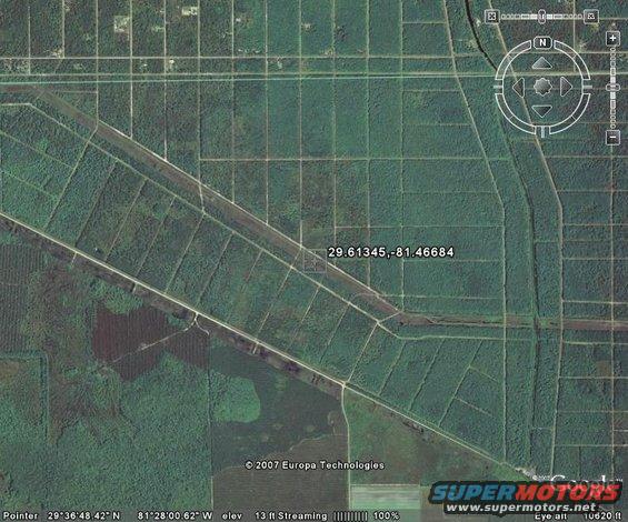 Aerial view of rectangular agricultural fields with roads, showing a grid pattern