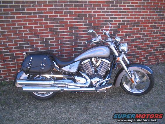 2006 Victory Kingpin motorcycle parked in front of a brick wall, showing its side profile with black saddlebags