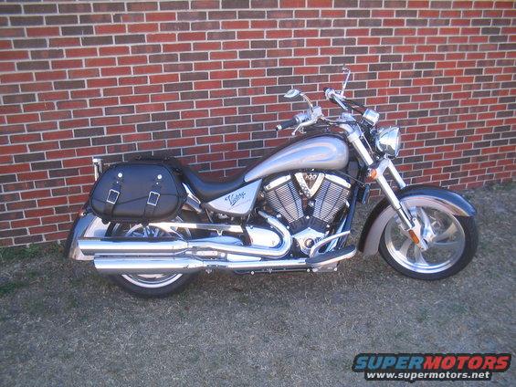 2006 Victory Kingpin motorcycle parked against a brick wall, showing black saddlebags