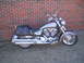 2006 Victory Kingpin - Side view of a 2006 Victory Kingpin motorcycle with saddlebags, parked outdoors.
