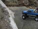 1996 Ford Bronco - A remote-controlled pickup truck is positioned on a rocky surface near a fallen tree.
