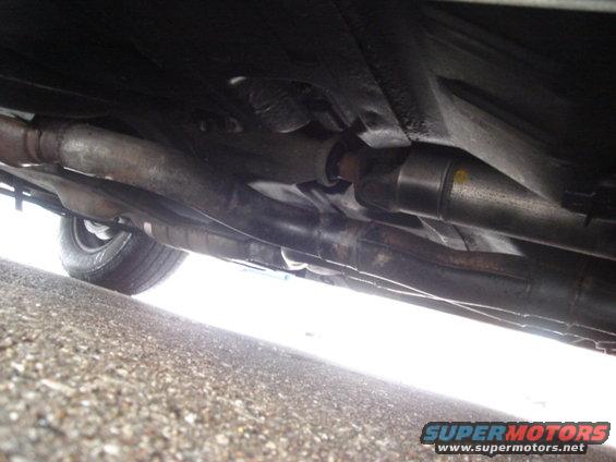 Underside view of vehicle exhaust and driveshaft