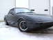 1983 Mazda RX-7 - A black 1983 Mazda RX-7 is shown in a three-quarter front view, parked on a snowy surface.