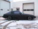 1983 Mazda RX-7 - Side view of a black Mazda RX-7 coupe with a dark tinted t-top roof.