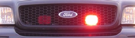 Ford grille with active red emergency lights