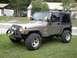 2004 Jeep TJ - This 2004 Jeep TJ features an aftermarket winch and decorative smiley face lights on the headlights.