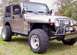 2004 Jeep TJ - This Jeep Wrangler features large off-road tires and a custom front bumper with a winch.