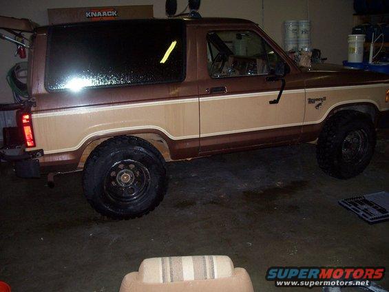 Brown and tan Ford Bronco II parked indoors, side view