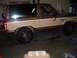 1984 Ford Bronco II - A two-tone brown and tan Ford Bronco II is shown from the side in what appears to be a garage.