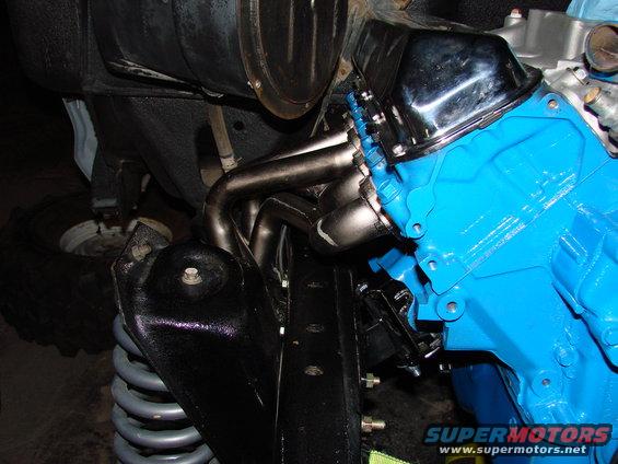 Blue engine block with chrome headers and exhaust manifold