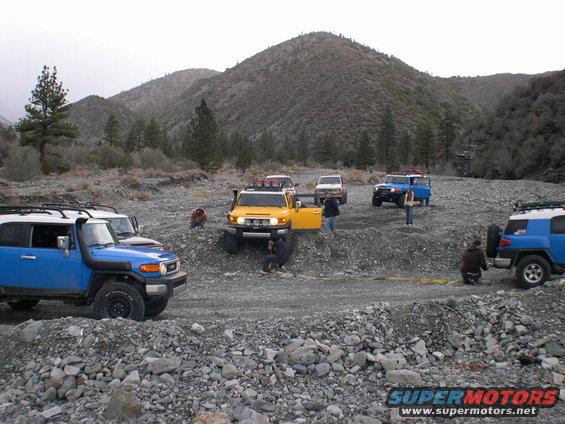 Blue and yellow 2007 Toyota FJ Cruisers parked in a rocky canyon
