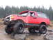 1989 Ford Bronco - This modified 1989 Ford Bronco navigates a challenging rocky course, equipped with a snorkel and large off-road tires.