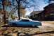 1973 Mercury Monterey - A light blue 1973 Mercury Monterey convertible sits parked on a dirt lot next to a rustic wooden house under a clear sky.