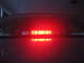 2000 Ford Crown Victoria - The rear third brake light of a 2000 Ford Crown Victoria is illuminated, showing its distinctive LED pattern.