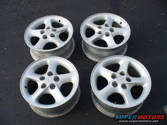 four silver 5-spoke alloy wheels
