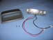2000 Ford Crown Victoria - Disassembled interior light assembly with housing and LED board.