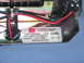 2000 Ford Crown Victoria - Close-up of a Federal Signal Corporation Universal LED CHMSL part, model 4W7J-15C596-AA, in red, with 12 volts indicated.