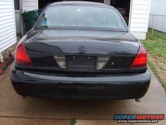 Black Mercury Marauder parked in driveway, rear view. Has 'Marauder' text on bumper