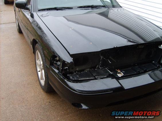 Black 1993 Ford Crown Victoria front end with damaged grille and headlight