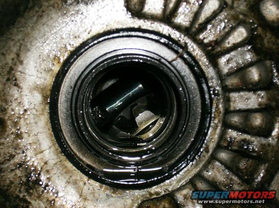 Worn bearing inside greasy housing