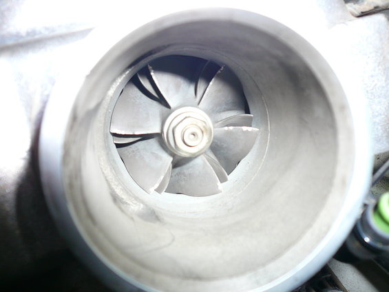 close-up of a turbocharger's compressor wheel with visible wear