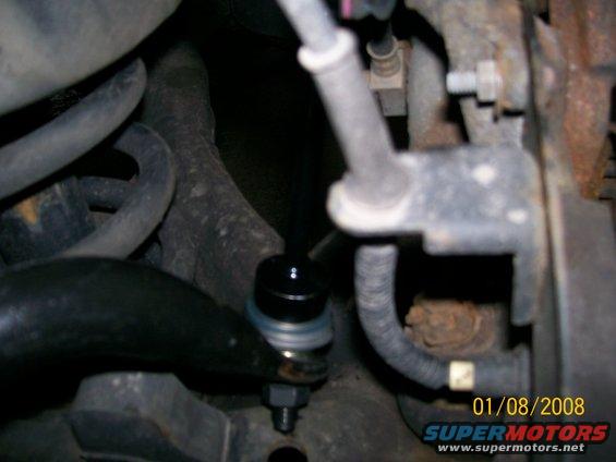 Close-up of a car's front sway bar end link with a date stamp of 01/08/2008
