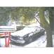 1973 Ford Ranchero - A car sits covered in snow during winter, with a tree and wooden stairs nearby.