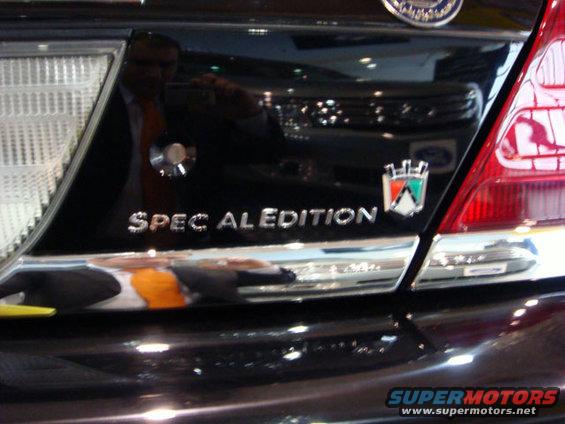 Black sedan's rear with 'SPEC AL EDITION' badge and a crest emblem