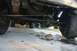 1991 Ford Bronco - Close-up of a truck's undercarriage, focusing on the rear axle and suspension components.