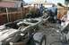 1991 Ford Bronco - The frame of a vehicle is shown with its engine and drivetrain components, undergoing work in a yard.