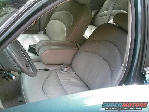 Interior view of a 1995 Ford Crown Victoria showing front and rear leather seats, center console, and steering wheel