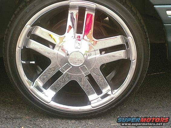 Chrome wheel with five spokes and a black tire
