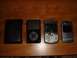 1996 Ford Bronco - A collection of electronic devices, including an iPod, a BlackBerry, and a Motorola RAZR, are laid out on a wooden table.