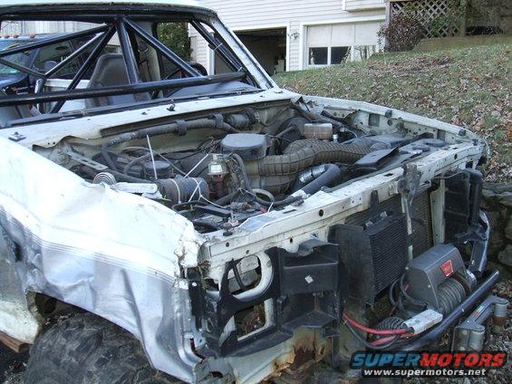 1995 Ford Bronco engine bay with roll cage and winch installed
