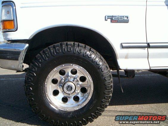 White 1992 Ford F-250 XLT truck, front fender and wheel detail